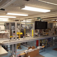 A lab room filled with robotic equipment and cages